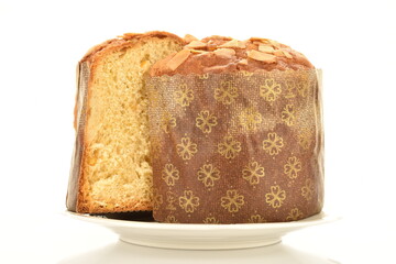 Two halves of a freshly baked Easter muffin on a ceramic plate, macro, isolated on white.