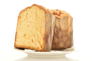 Two halves of a freshly baked Easter muffin on a ceramic plate, macro, isolated on white.