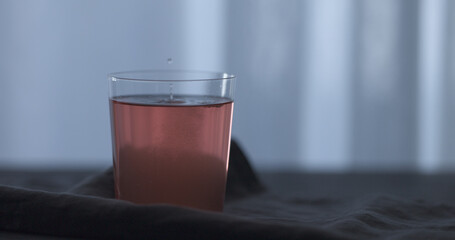 rose drink in tumbler glass on linen cloth