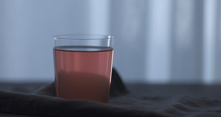 rose drink in tumbler glass on linen cloth