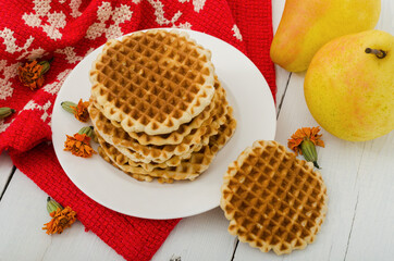 Appetizing round waffles on a white plate