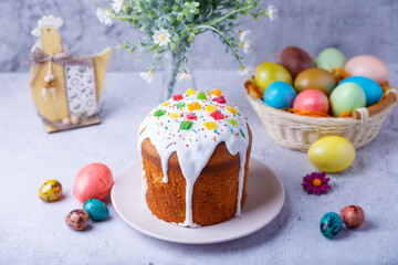 Obraz na płótnie Canvas Easter cake with candied fruits and colored eggs. Traditional Easter baking. Easter holiday. Close-up.