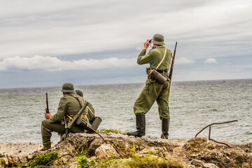 Historical reenactment. German soldiers during the Second World War. Wehrmacht soldiers patrol the ...