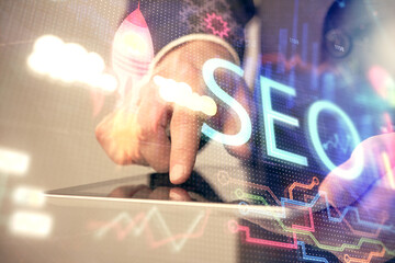 Multi exposure of man's hands holding and using a digital device and seo drawing. search...