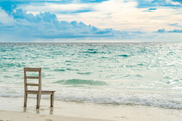 Panoramic view of a tropical beach with palm trees, turquoise waters and blue sky in the Maldives, Indian Ocean