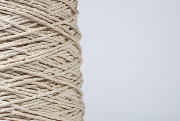 Close-up of a spool of thread macro texture isolated on white background with copy space