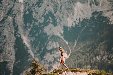 Woman standing at the top of the hill in mountains looking at wonderful scenery. Triglav, the...