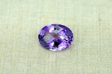 Natural Uruguay amethyst gemstone. Oval checker faceted, big size violet or purple color loose crystal clear stone setting for making jewelry. Canvas background.