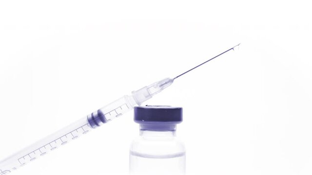 small glass bottle and syringe with the vaccine or medical supplies on a white background
