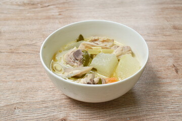 spicy boiled winter melon with chicken bone tom yum soup in bowl