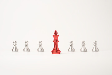 Red king chess in front of pawn chess on white background , Leadership concept.