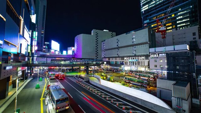 A night timelapse of the neon street near Shibuya station wide shot tilt