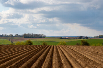 Fototapeta premium Cultivated farmland in the South Limburg country side in the Netherlands with the fields plowed, which brings interesting lines into the landscape