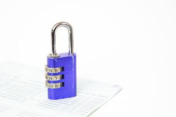 Close up Blue key or padlock locked on account passbook on white background. saving and financial concept , financial business security or account security. Copy space.