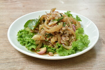 Thai spicy chop pork and slice skin salad with fresh vegetable on plate
