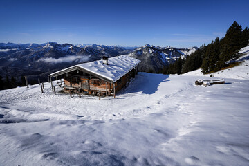 Fototapeta na wymiar Wonderful wooden hut in snow covered mountains