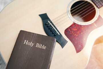 Christians worship God with a guitar with the Holy Bible. reading the Bible and sharing the gospel with copy space for the word of god. - obrazy, fototapety, plakaty