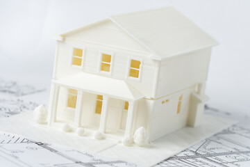 Model of the family house printed on a 3D printer with white filament by FDM technology for...