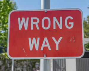 Close-up of a wrong way sign.