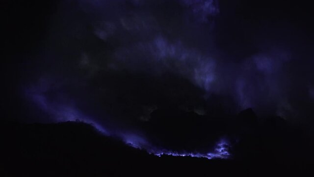 Blue fire of burning sulfur in a crater of a volcano Kawah ijen, Java, Indonesia. Famous tourist attraction, where sulfur is mined. Ijen volcano complex is a group of stratovolcanoes in the Banyuwangi