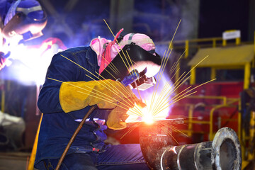 Industrial business with metal welding process at factory for ship repair in shipyard