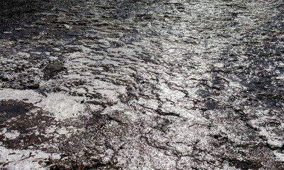 Ice, after the snow melts and freezes on the mountainside close-up in spring (Background, banner, Wallpaper)