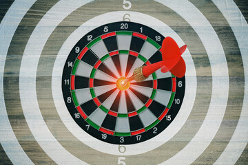 Double exposure dart board, center dart on old wooden wall background, goal and concept of success