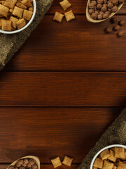 Breakfast cereal: a plate with pillows,chocolate balls on the table. Copy space