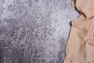 Cracked stone, concrete texture backround, copyspace and right side frame created by beige kitchen table cloth