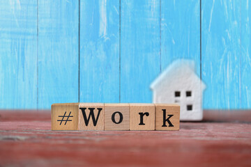 WORK word on wooden blocks on blue wooden background