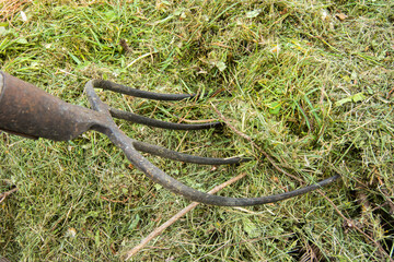 Stuck pitchfork in a haystack. Close-up view