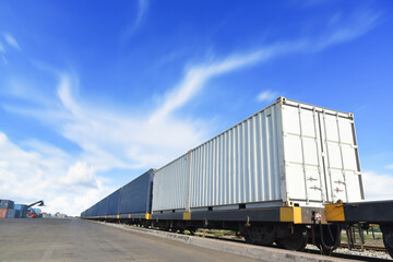 Fototapeta na wymiar Freight Train with Cargo Containers, Transport, Shipping import Export on blue sky background