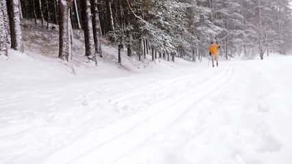 Man in yellow jacket skiing on the mountain. High quality photo