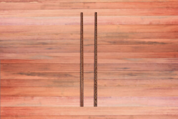 Top view of wooden chopsticks on wooden background.