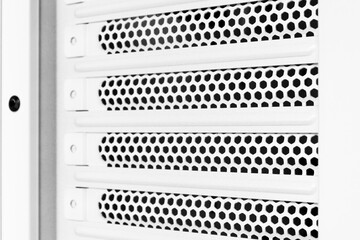 Horizontal ventilation grille. Air vents. Metal construction. Angle view. Black and white tones.
