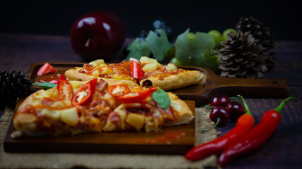 Delicious Italian Pizza with Red Chili And draw chili sauce on the wooden plan where the pizza is placed On a dark wood floor