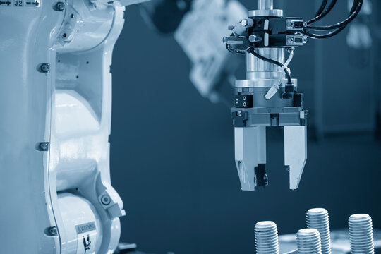 The hi-technology  material handling process by robotic system. The automatic pneumatic robotic arm picking the container box in production line.