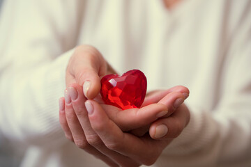 Female hands holding red heart. Love photo. Background. Red heart. 