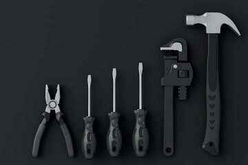 Top view of monochrome construction tools for repair and installation on black