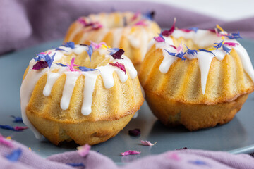 three small decorated cakes on a plate