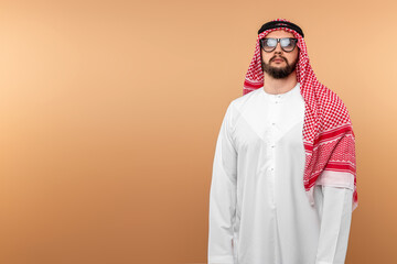 A Saudi Arab man in national dress and sunglasses. Dishdasha, kandora, thobe, islam. Copy space.