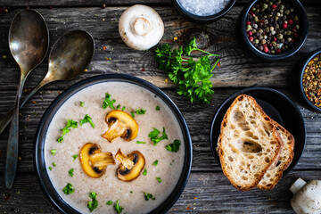 Cream of mushroom soup on wooden table
