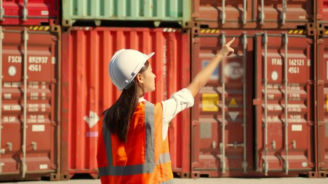 Professional female engineer hand count cargo container to check amount of product,Logistic Worker Checking Cargo Container Manager and assistant inspecting the items in the containe