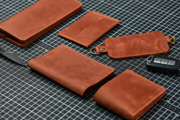 Set of handmade leather goods, key holder rings, wallet, purse, notepad, handbook. Handcrafted leather goods, close-up