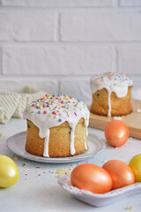 Easter cakes and colored eggs on a white table