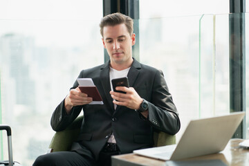 Confident business Man with smartphones in airline lounges