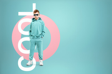 Portrait, cute stylish boy in a blue suit on a blue background. Studio portrait of a child, modern design, trendy background, turquoise. The lettering is cool.