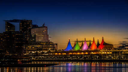 Naklejka premium Blue Hour after the Sun has set over the Harbor and the Colorful Sails of Canada Place, the Cruise Ship Terminal and Convention Center on the Waterfront of Vancouver, British Columbia, Canada