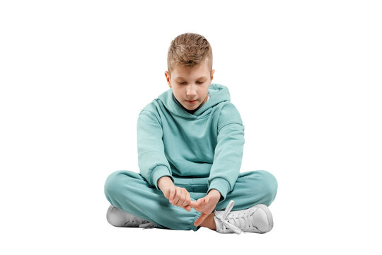 Boy In Turquoise Blue Tracksuit Isolated On White Background.