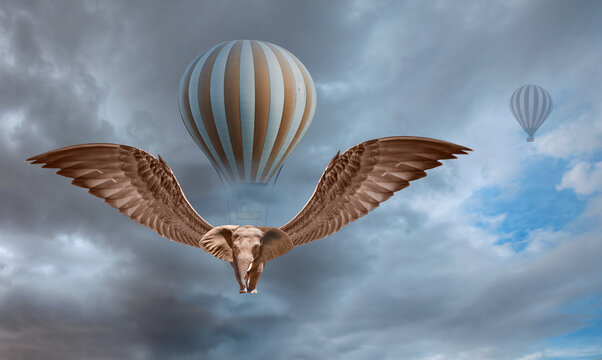 A flying winged elephant flies an hot air balloon